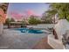 Backyard with a freeform swimming pool, outdoor kitchen, and ample seating under a gazebo at 2726 E Hale St, Mesa, AZ 85213