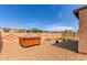 Backyard view showcasing a hot tub, fire pit, small patch of grass, and charming decorative block wall at 29193 N Mountain View Rd, San Tan Valley, AZ 85143