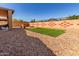 Wide backyard with gravel, artificial grass, hot tub, and decorative block wall at 29193 N Mountain View Rd, San Tan Valley, AZ 85143