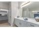 Bright bathroom with double sinks, white cabinets, walk-in closet and separate shower at 29193 N Mountain View Rd, San Tan Valley, AZ 85143