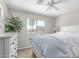 Cozy bedroom with a large window, wood floors, and a ceiling fan at 29193 N Mountain View Rd, San Tan Valley, AZ 85143