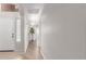 Inviting hallway with laminate wood floors, neutral paint, and ample natural light at 29193 N Mountain View Rd, San Tan Valley, AZ 85143