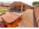 Backyard features a hot tub, gravel, artificial grass, and covered patio at 29193 N Mountain View Rd, San Tan Valley, AZ 85143