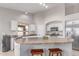 Bright kitchen features stainless steel appliances, white cabinets, and a spacious island with seating at 29193 N Mountain View Rd, San Tan Valley, AZ 85143