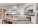 Beautiful kitchen island with white cabinets, stainless steel appliances, and a breakfast bar at 29193 N Mountain View Rd, San Tan Valley, AZ 85143