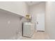Clean laundry room with a washer, dryer, and upper shelf storage at 29193 N Mountain View Rd, San Tan Valley, AZ 85143