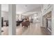 Open-concept living room with stone fireplace, tile floors, and seamless flow to kitchen at 29193 N Mountain View Rd, San Tan Valley, AZ 85143