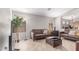 Cozy living room featuring plush leather seating, laminate floors, and soft natural light at 29193 N Mountain View Rd, San Tan Valley, AZ 85143