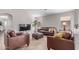 Comfortable living room with leather furniture, light wood floors, and plenty of space for relaxation at 29193 N Mountain View Rd, San Tan Valley, AZ 85143