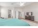 This bright main bedroom features a ceiling fan, a large area rug, and ensuite bathroom at 29193 N Mountain View Rd, San Tan Valley, AZ 85143