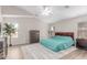 This bright main bedroom features a ceiling fan, a large area rug, and windows at 29193 N Mountain View Rd, San Tan Valley, AZ 85143