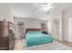 This bright main bedroom features a ceiling fan, a large area rug, and ensuite bathroom at 29193 N Mountain View Rd, San Tan Valley, AZ 85143