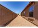 Gravel-covered side yard with block wall extending along the property line at 29193 N Mountain View Rd, San Tan Valley, AZ 85143