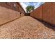 Long gravel-covered side yard with block wall and view of the home's exterior at 29193 N Mountain View Rd, San Tan Valley, AZ 85143