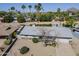 This aerial view features a neutral-toned roof, landscaped front yard, and a serene neighborhood setting with mature palm trees at 3138 N 82Nd Pl, Scottsdale, AZ 85251