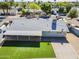 This aerial shot displays a home with an ample green lawn, neutral-toned roof, and inviting outdoor patio area at 3138 N 82Nd Pl, Scottsdale, AZ 85251