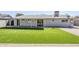 Backyard featuring artificial turf, covered patio, and white brick exterior at 3138 N 82Nd Pl, Scottsdale, AZ 85251