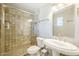 Bathroom featuring tiled shower with glass door, pedestal sink, and ample lighting at 3138 N 82Nd Pl, Scottsdale, AZ 85251