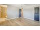 Bedroom with light wood floors featuring ensuite bathroom and gray paneled doors at 3138 N 82Nd Pl, Scottsdale, AZ 85251