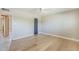 Spacious bedroom featuring light wood floors, neutral gray walls, and paneled door at 3138 N 82Nd Pl, Scottsdale, AZ 85251