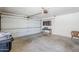 This garage features a clean, open space with a functional cabinet table and ample room for parking and storage at 3138 N 82Nd Pl, Scottsdale, AZ 85251
