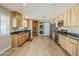 Spacious kitchen with light wood cabinets, stainless steel appliances and light wood floors at 3138 N 82Nd Pl, Scottsdale, AZ 85251