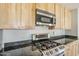 Updated kitchen with stainless steel gas range and black countertops at 3138 N 82Nd Pl, Scottsdale, AZ 85251
