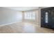 Inviting living room featuring hardwood floors, plantation shutters, neutral paint, and stylish entry door at 3138 N 82Nd Pl, Scottsdale, AZ 85251