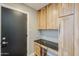Office area with light wood cabinets, granite countertops and dark hardware at 3138 N 82Nd Pl, Scottsdale, AZ 85251