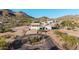 Expansive aerial view of a luxury home nestled in a desert landscape with mountain views and circular driveway at 3333 N 87Th St, Mesa, AZ 85207