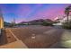 Expansive backyard featuring low-maintenance desert landscaping and mountain views under a colorful sky at 3333 N 87Th St, Mesa, AZ 85207