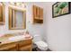 A well-lit bathroom with a decorative mirror and granite countertops at 3333 N 87Th St, Mesa, AZ 85207