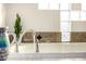 Bathroom features a uniquely shaped glass block window, stylish decor, and elegant fixtures at 3333 N 87Th St, Mesa, AZ 85207