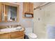 Bathroom featuring a mirror, granite countertop, toilet, and shower with glass doors at 3333 N 87Th St, Mesa, AZ 85207