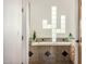 Bathroom features a unique cactus shaped glass block window and decorative tile surround at 3333 N 87Th St, Mesa, AZ 85207