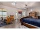Bedroom featuring a king-sized bed, a desk, a table with chairs, and hardwood floors at 3333 N 87Th St, Mesa, AZ 85207