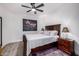 Cozy bedroom featuring a ceiling fan, wood-look floors, and a modern minimalist aesthetic at 3333 N 87Th St, Mesa, AZ 85207