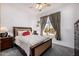 Bedroom features a floral bedspread, side tables with lamps and an exterior view at 3333 N 87Th St, Mesa, AZ 85207