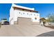 Southwestern-style home featuring a spacious garage, smooth driveway, and subtle desert architectural accents at 3333 N 87Th St, Mesa, AZ 85207