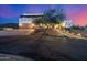 Elegant Southwestern home featuring a spacious driveway, desert landscaping, and a charming illuminated walkway at 3333 N 87Th St, Mesa, AZ 85207