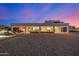 The back exterior of the home has ample space, a patio, and desert landscaping, perfect for entertainment at 3333 N 87Th St, Mesa, AZ 85207