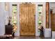 Inviting entryway with a handcrafted wooden door and colorful stained glass sidelights at 3333 N 87Th St, Mesa, AZ 85207