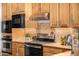 Granite countertops and stainless steel appliances complement the natural wood cabinets at 3333 N 87Th St, Mesa, AZ 85207