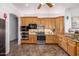 Kitchen with modern appliances, wood cabinets and an adjacent breakfast area at 3333 N 87Th St, Mesa, AZ 85207