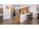 Open kitchen area with breakfast bar and matching wooden barstools at 3333 N 87Th St, Mesa, AZ 85207