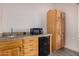 Kitchenette area featuring cabinets, countertops, a microwave, and a mini-fridge at 3333 N 87Th St, Mesa, AZ 85207