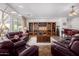Elegant living room with a built-in entertainment center, leather furniture, and bright lighting at 3333 N 87Th St, Mesa, AZ 85207