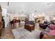 Spacious living room features a grand piano and comfortable leather furnishings at 3333 N 87Th St, Mesa, AZ 85207