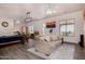 Open concept living room with hardwood floors, ceiling fans, and Arizona state flag at 3333 N 87Th St, Mesa, AZ 85207