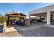 Relaxing outdoor space with a covered kitchen, outdoor kitchen, and hot tub at 3333 N 87Th St, Mesa, AZ 85207